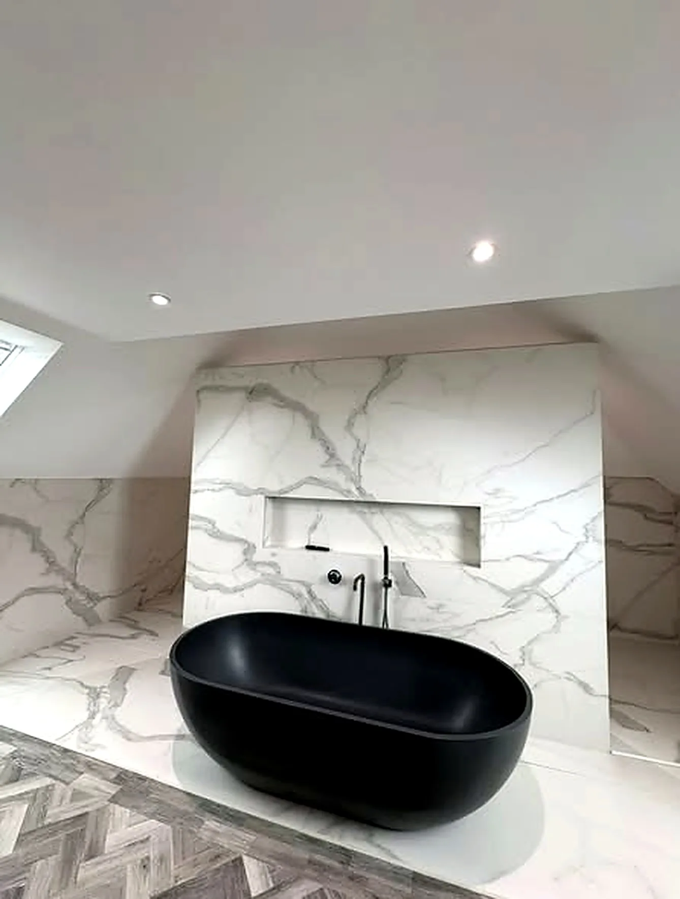 Clean bathroom suite with black bath