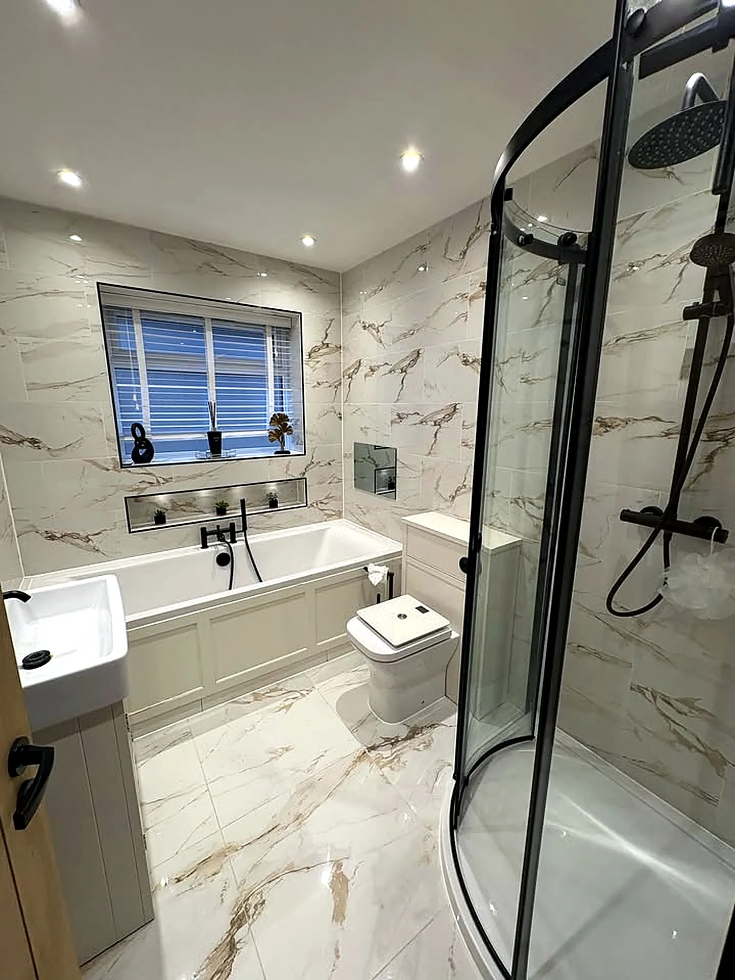 Finished marble bathroom with shower and bath