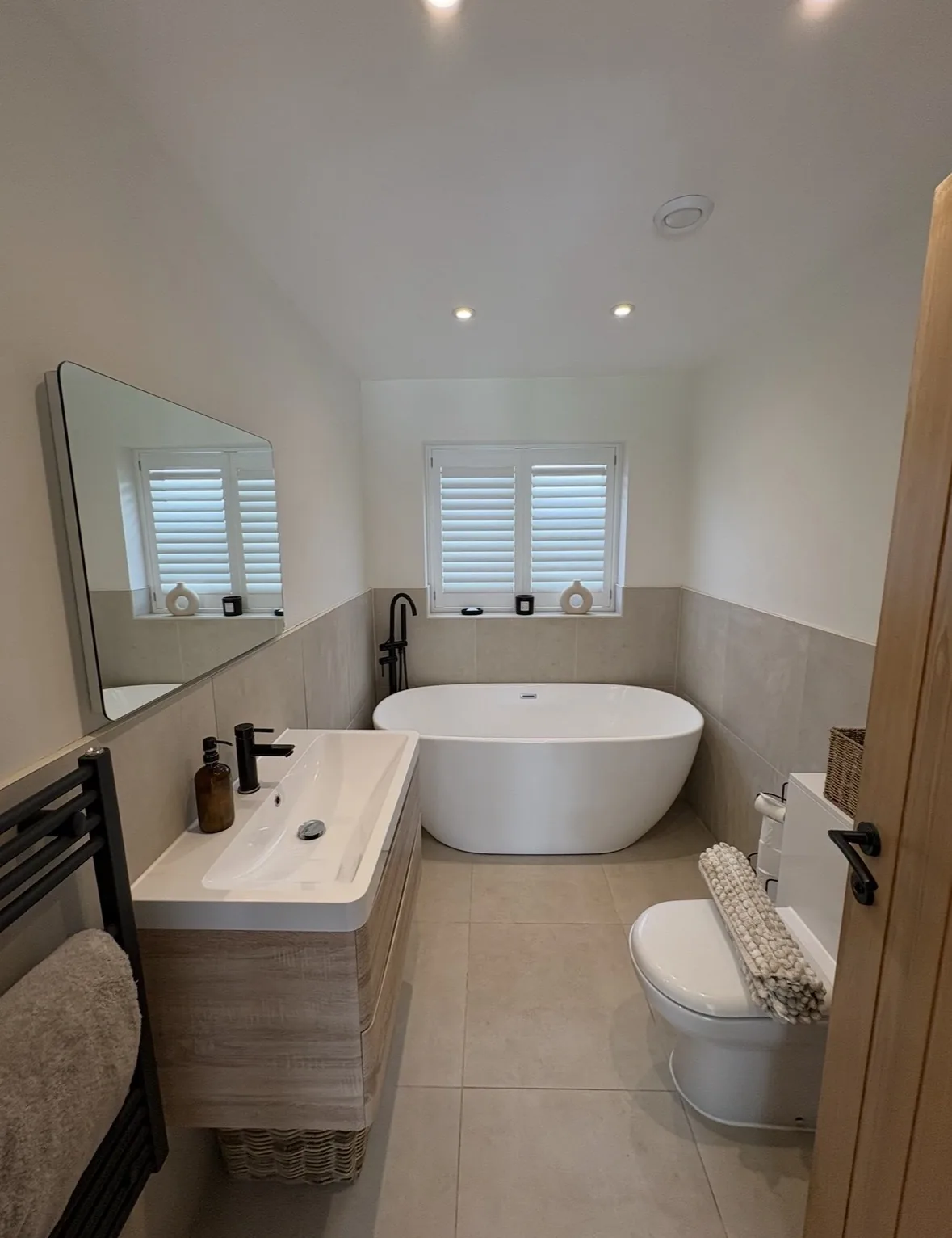 Freshly cleaned bathroom with freestanding bath and vanity unit