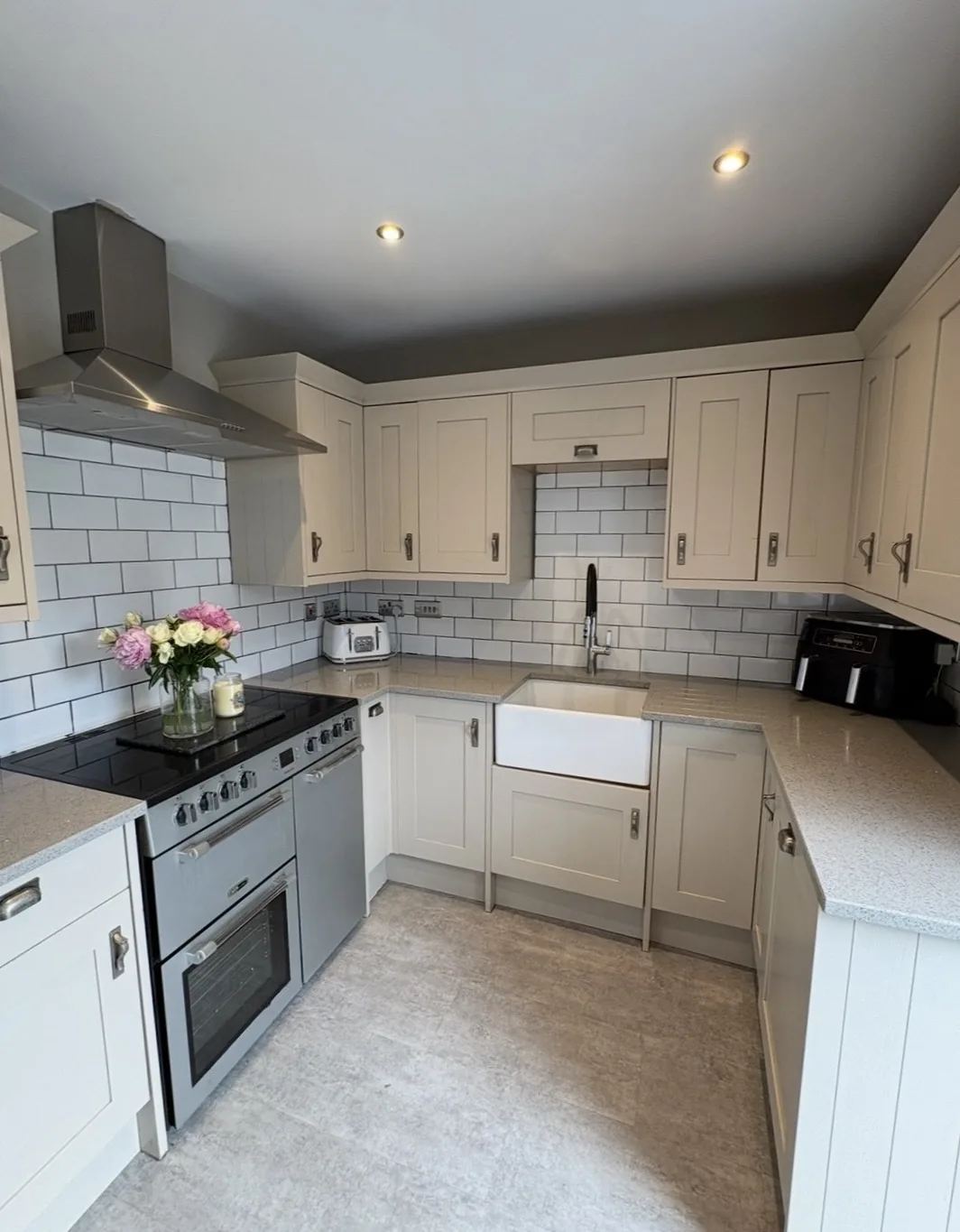 Freshly cleaned cream kitchen with tiled splashback
